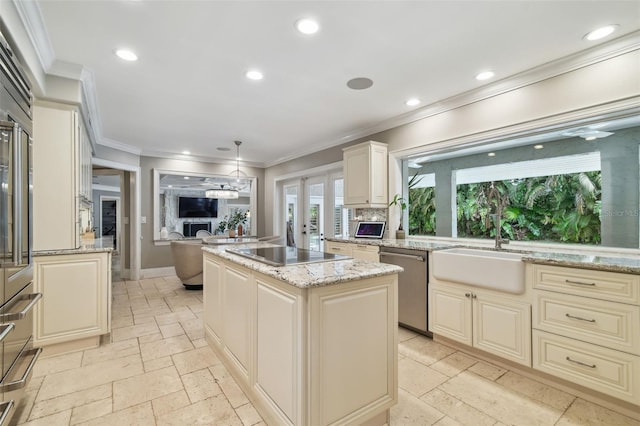 kitchen with stainless steel dishwasher, decorative light fixtures, light stone countertops, a center island, and black electric cooktop