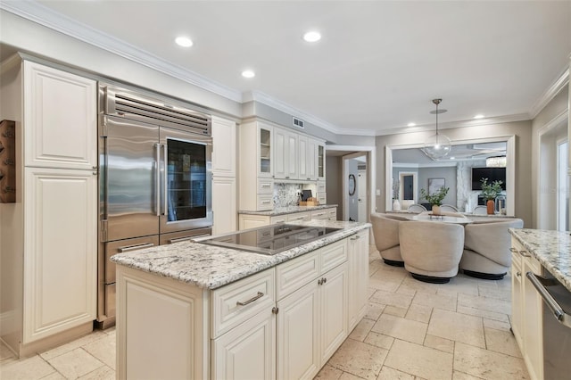 kitchen featuring a center island, light stone countertops, white cabinets, pendant lighting, and stainless steel appliances