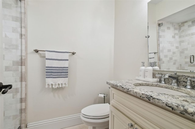 bathroom featuring vanity, toilet, and a shower with door