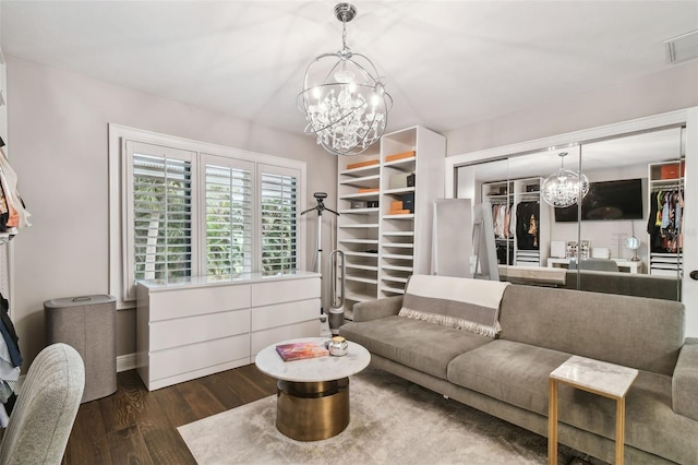 living room featuring dark hardwood / wood-style floors and a notable chandelier