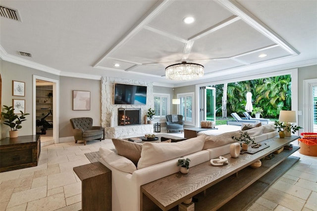 living room with a fireplace, a chandelier, and ornamental molding