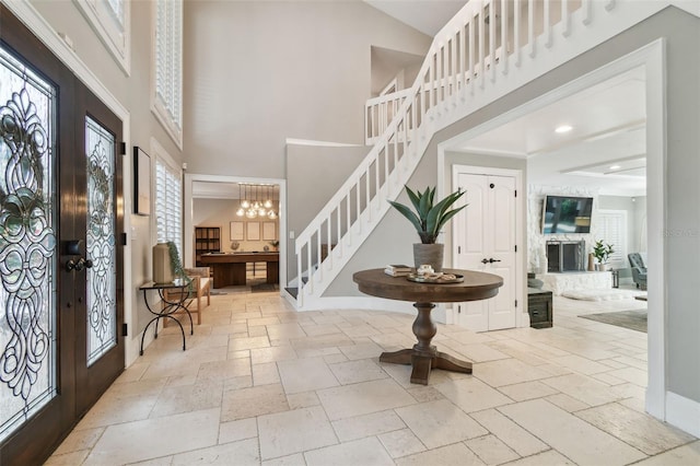 foyer entrance with a high ceiling and an inviting chandelier