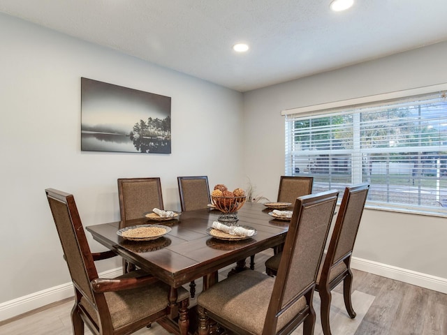 dining space with light wood-type flooring