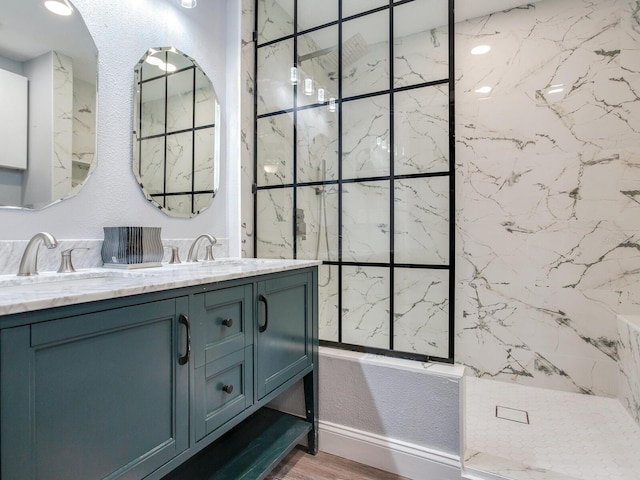 bathroom with vanity, tiled shower, and hardwood / wood-style floors