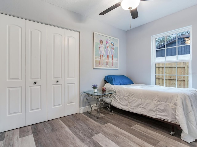 bedroom featuring a closet, ceiling fan, and light wood-type flooring