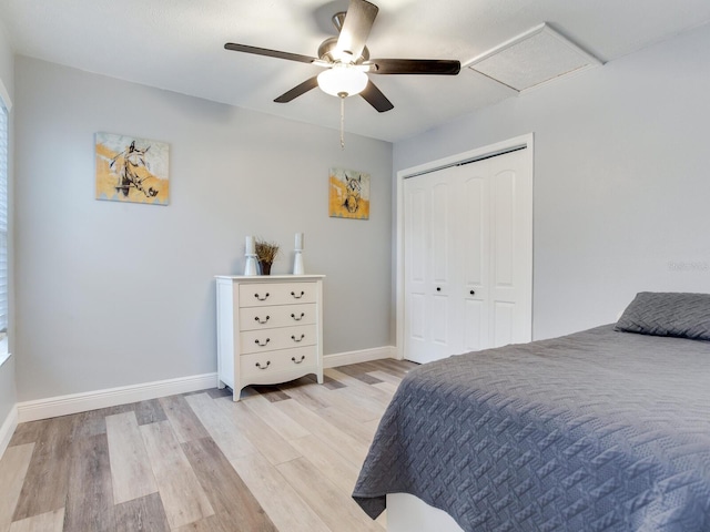 bedroom featuring ceiling fan, light hardwood / wood-style floors, and a closet