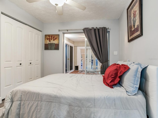 bedroom featuring ceiling fan, a closet, and a textured ceiling