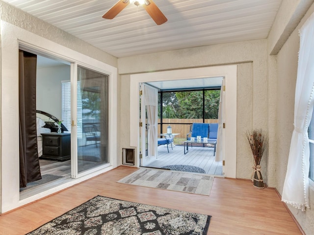 doorway to outside featuring ceiling fan and light hardwood / wood-style flooring