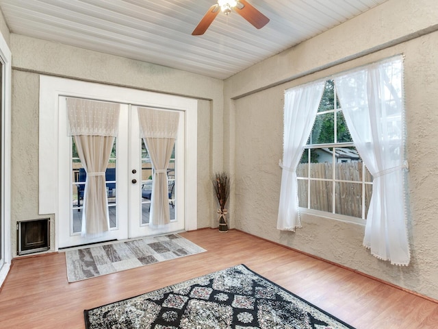 sunroom / solarium featuring french doors and ceiling fan