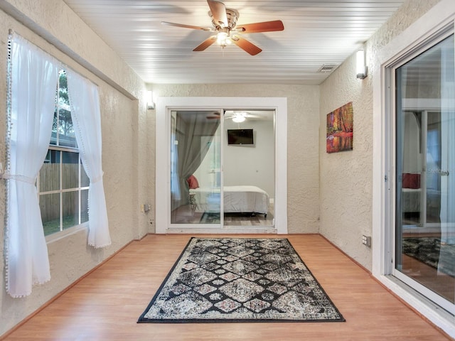 interior space with ceiling fan and hardwood / wood-style floors