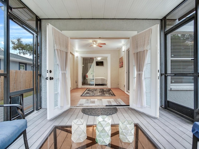 sunroom featuring french doors and ceiling fan