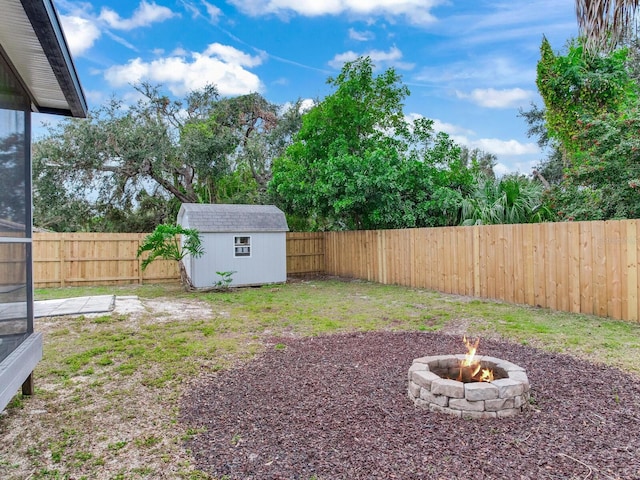 view of yard with a fire pit and a storage unit