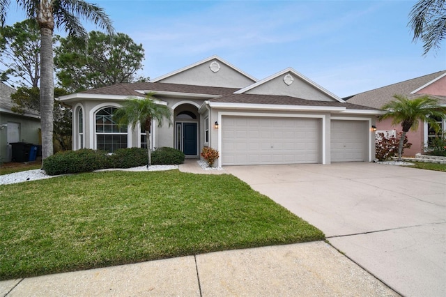 ranch-style house featuring a front lawn and a garage