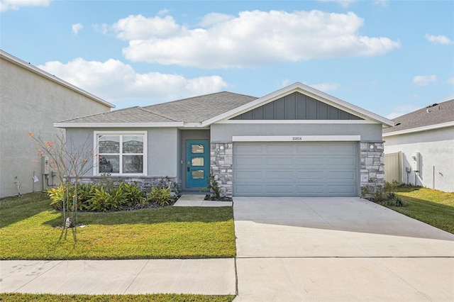 view of front of property with a front yard and a garage