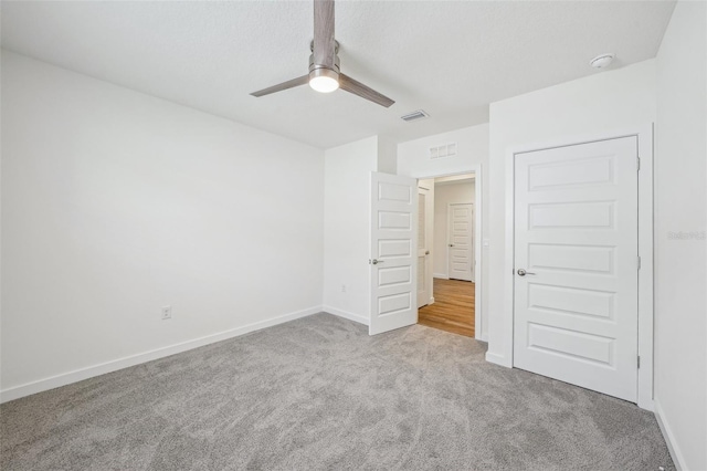 unfurnished bedroom with a closet, ceiling fan, and light carpet