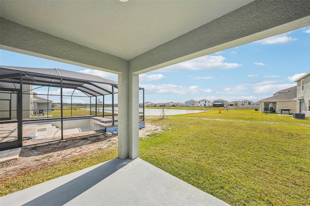 view of yard featuring glass enclosure, a patio area, a water view, and central air condition unit