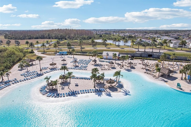 birds eye view of property featuring a water view and a beach view