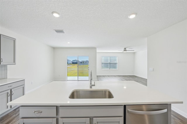 31814 Oyster Trellis Ln, Wesley Chapel, FL 33545 - kitchen with gray cabinetry, stainless steel dishwasher, a sink, open floor plan, and light countertops