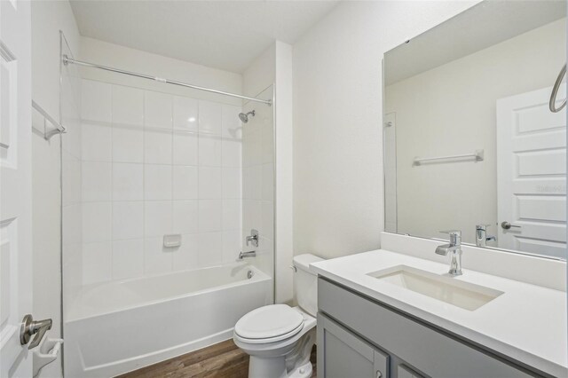 31814 Oyster Trellis Ln, Wesley Chapel, FL 33545 - bathroom with toilet, vanity, wood finished floors, and  shower combination
