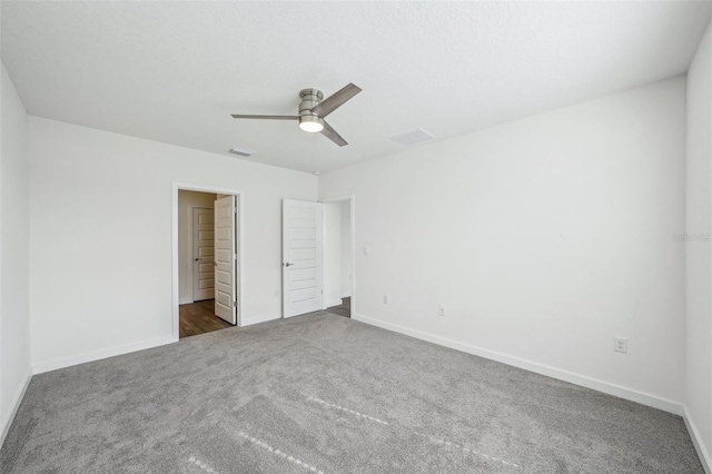 31814 Oyster Trellis Ln, Wesley Chapel, FL 33545 - unfurnished bedroom featuring dark colored carpet, baseboards, and a ceiling fan
