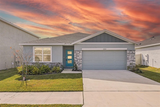 31814 Oyster Trellis Ln, Wesley Chapel, FL 33545 - view of front facade featuring stone siding, a yard, a garage, and concrete driveway