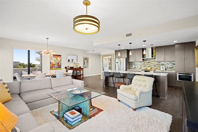 living room featuring dark hardwood / wood-style floors and a chandelier