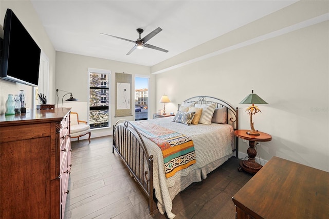 bedroom with ceiling fan and dark hardwood / wood-style floors