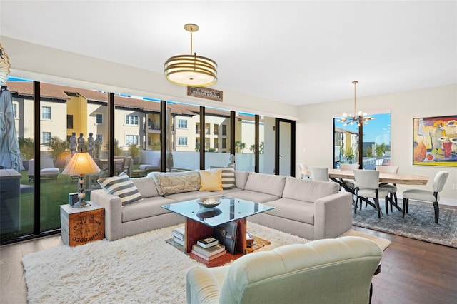 living room featuring wood-type flooring and a notable chandelier