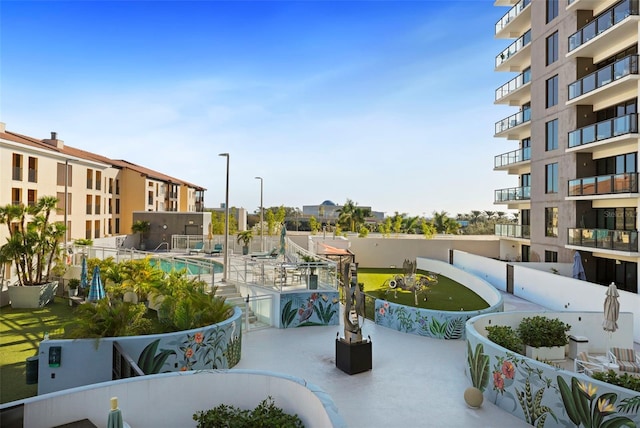 surrounding community featuring a pool and a patio