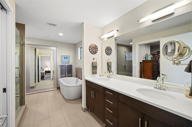 bathroom with vanity, tile patterned floors, and shower with separate bathtub