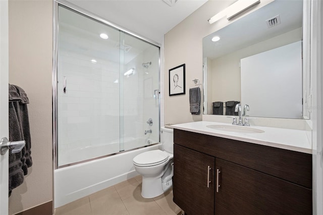 full bathroom with toilet, tile patterned floors, vanity, and enclosed tub / shower combo