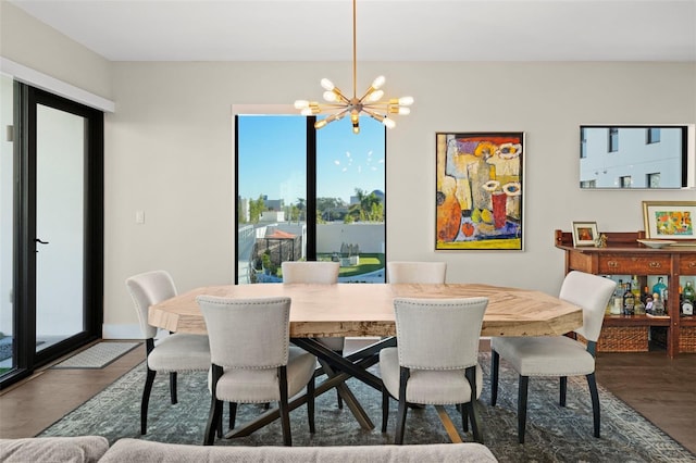 dining room with dark wood-type flooring and a chandelier