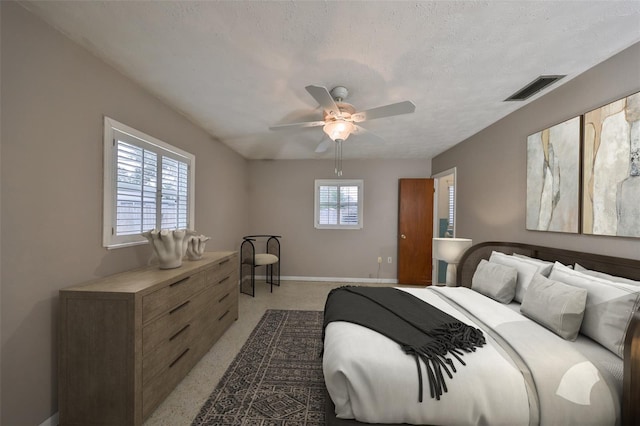 bedroom with ceiling fan and a textured ceiling