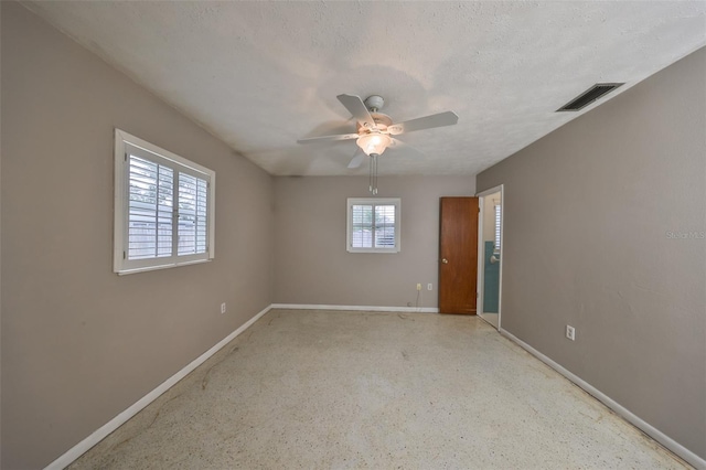 spare room with ceiling fan and a textured ceiling