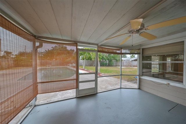 unfurnished sunroom featuring ceiling fan