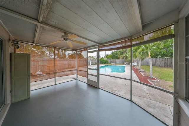 unfurnished sunroom featuring ceiling fan