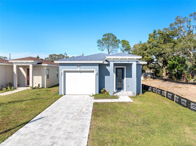 view of front of property with a front yard and a garage