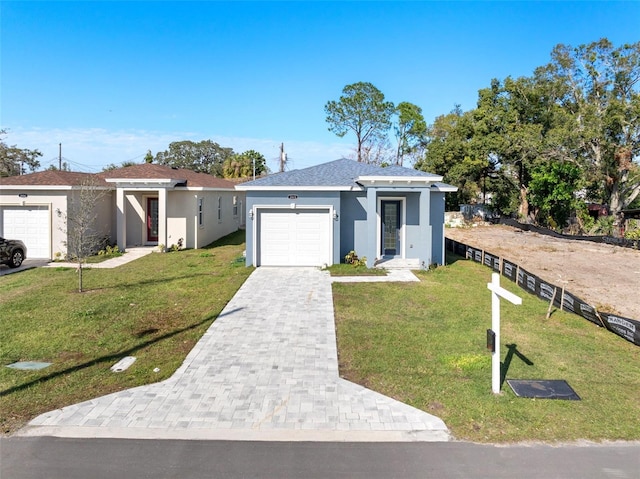 view of front facade with a garage and a front yard