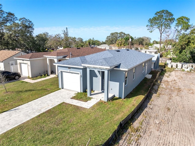 ranch-style house with a front lawn and a garage