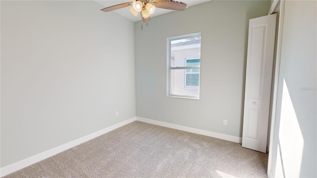 spare room featuring ceiling fan and light colored carpet