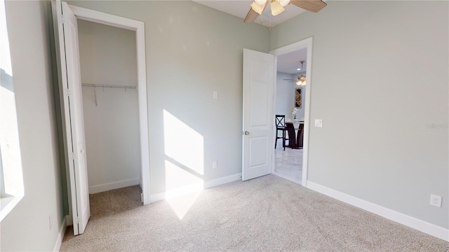 unfurnished bedroom with ceiling fan, light colored carpet, and a closet