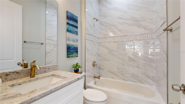 full bathroom with toilet, tiled shower / bath combo, and vanity