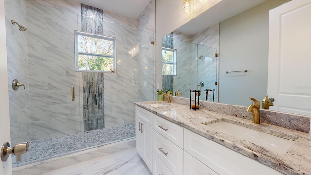 bathroom with a shower with shower door and vanity