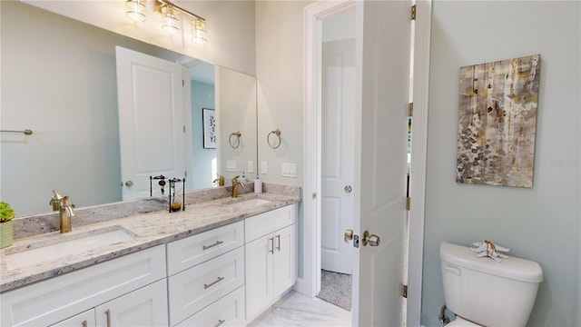 bathroom with toilet and vanity