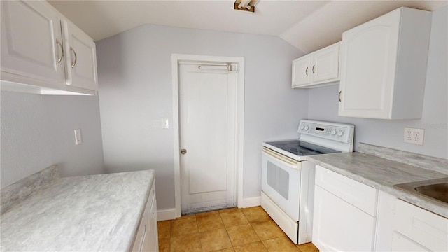 kitchen with light tile patterned flooring, vaulted ceiling, white cabinets, white range with electric cooktop, and sink