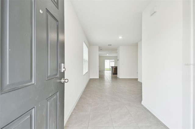 hallway with light tile patterned floors