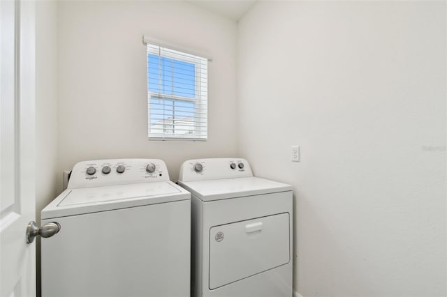 clothes washing area featuring washer and dryer