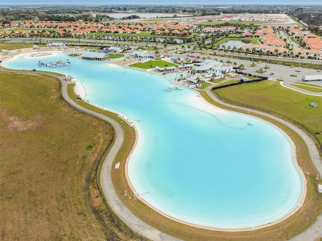 aerial view with a water view and a beach view