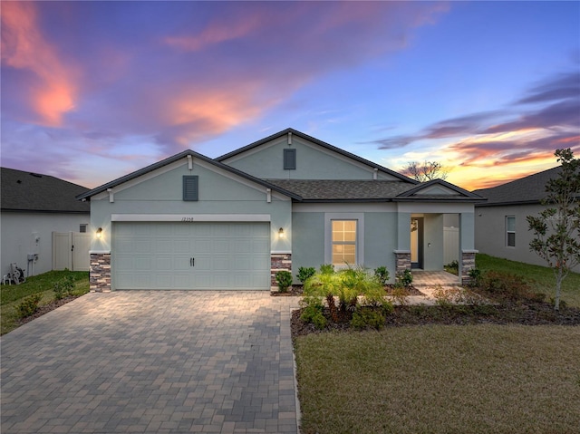 view of front of house with a garage and a lawn