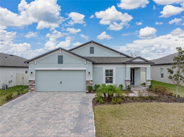 single story home featuring a front lawn and a garage